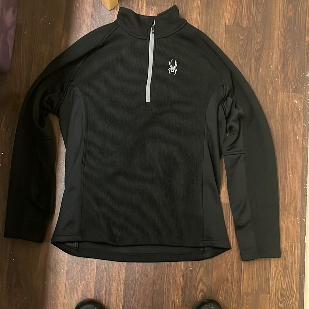 A black and grey spyder pocketless ski jacket.